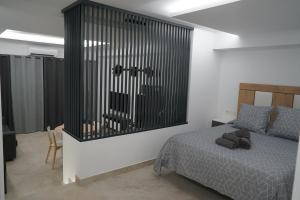 Łóżko lub łóżka w pokoju w obiekcie Apartamento Turistico Hermanos Infantes
