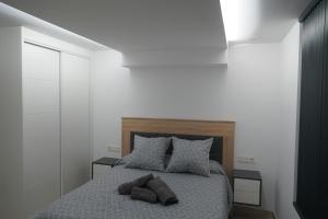 Łóżko lub łóżka w pokoju w obiekcie Apartamento Turistico Hermanos Infantes