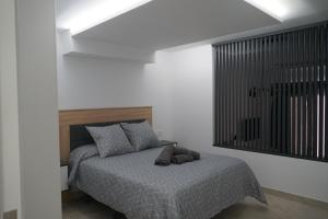 Łóżko lub łóżka w pokoju w obiekcie Apartamento Turistico Hermanos Infantes