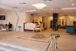 a lobby with a statue of a woman on a stool at Asafra Hotel Apartments Egyptian only price in Alexandria