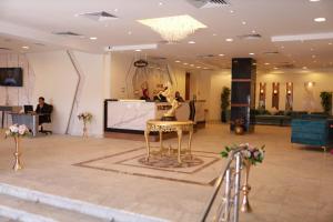 a lobby with a statue of a woman on a stool at Asafra Hotel Apartments in Alexandria