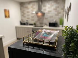 a magazine sitting on top of a table in a kitchen at Luxurious New 2 Bed Apartment in Burnley, Lancashire in Burnley