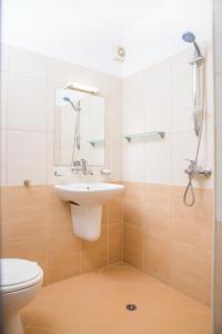 a bathroom with a toilet and a sink and a shower at Family Hotel Sunrise in Lozenets +24 photos
