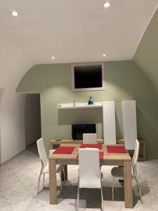 a dining room with a table with chairs and a tv at Casa - Torre dell'Orologio in Canosa di Puglia