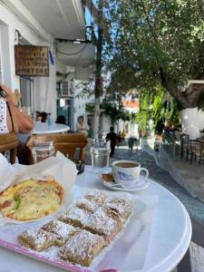a table with a plate of food and a cup of coffee at Katoi House - Central Skyros Village in Skiros