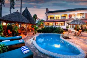 a villa with a swimming pool in front of a house at 2 Friends Beach Hotel in Entebbe