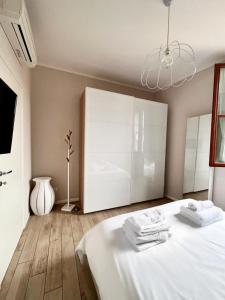 a bedroom with a bed and a large white cabinet at Casa Nanà in Florence