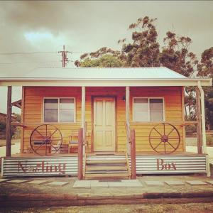 a small wooden house with two large wheels on it at Bukirk Glamping & Fancy Coops in Clare