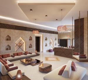 sala de estar con 2 sofás y TV en Sidra Resort, en Buqayq