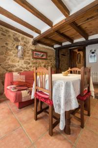 Un comedor con una mesa y un sofá. en CASA PETRA, en Miranda del Castañar