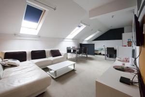 a living room with a couch and a table at Centar W in Osijek