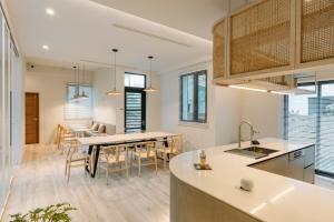 a kitchen and dining room with a table and chairs at Blinghouse in Hualien City