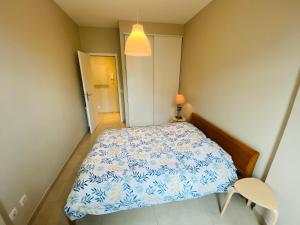 a small bedroom with a bed and a chair at Le Delfino PORT DE NICE in Nice