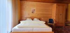 a bedroom with two beds in a wooden room at Pension Vinkl in Harrachov