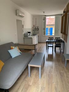 a living room with a couch and a table at Marseille LOFT 50m2 au cœur du Cours Julien in Marseille