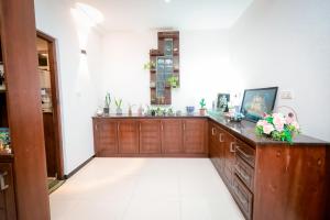 a large room with a counter with flowers on it at Howick Residence in Katunayake