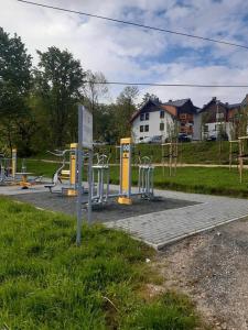 a park with a bunch of stations in the grass at Apartament Dream Apart II in Szklarska Poręba