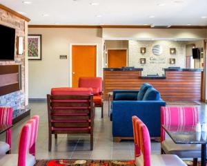 a waiting room with colorful furniture in a restaurant at Comfort Inn & Suites Coralville - Iowa City near Iowa River Landing in Coralville