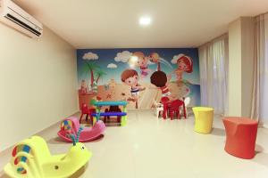 a room with many different colored chairs and a mural at Sun Residence in Fortaleza +27 photos