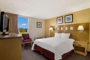 a hotel room with a bed and a television at Quality Inn in Alice