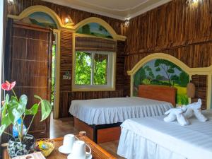 two beds in a room with wooden walls at Ninh Binh Greenland Homestay in Ninh Binh +106 photos