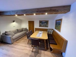 a living room with a table and a couch at Landhaus Zillertal in Ramsau im Zillertal