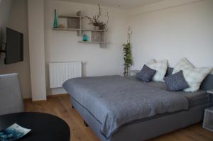 a bedroom with a bed and a couch at Privatweingut Schmidt in Heitersheim