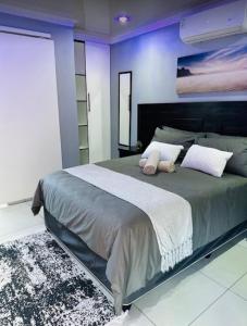 a bedroom with a large bed with two pillows at Sekos Guest House & Shisanyama in St Lucia