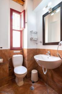 a bathroom with a toilet and a sink and a mirror at Lively Lofts by The Varos Residences in Város