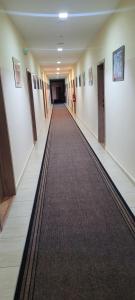 a long hallway with a carpet in a building at Penzion Burra in Vrútky