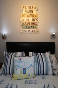 a bedroom with a bed with a sign on the wall at The Pebbles - Adults Only in Weymouth