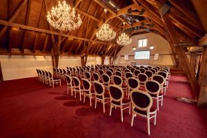 a room with rows of chairs and chandeliers at Château Salavaux in Salavaux