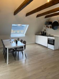 uma cozinha e sala de jantar com uma mesa branca e cadeiras em Søkig em Viborg