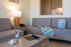 a living room with two couches and a table at Athineon Hotel in Rhodes Town