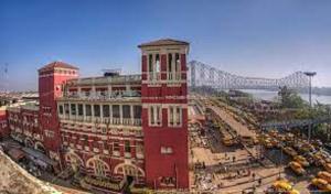 a large red building with a bridge in the background at YWCA GALLWAY GUEST HOUSE in Kolkata