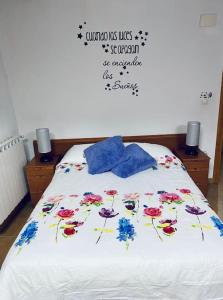 a bedroom with a bed with flowers on it at Alojamiento rural La Casona in Andorra