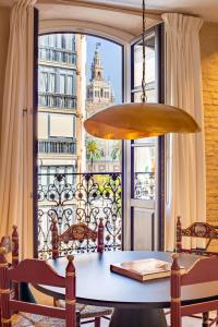 a dining room table with a view of a building at Real Casa de la Moneda Deluxe Apartments in Seville
