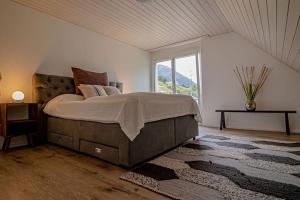 a bedroom with a large bed and a large window at New Chalet with breathtaking views! in Alt Sankt Johann