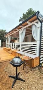 a black chair sitting on a deck with a house at Blue Wave Mobile Home in Biograd na Moru