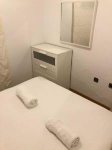 a bathroom with a bed with a mirror and a dresser at NEW! Apartment in Sarria near Metro in Barcelona