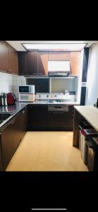 a kitchen with brown cabinets and a counter top at 仔鹿 kojika in Nara