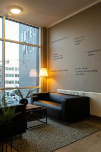 a hotel lobby with a couch and a large window at H&oacute;tel M&uacute;li in Reykjav&iacute;k