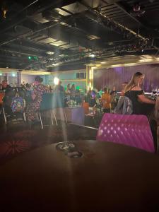 a group of people sitting in a room with purple chairs at Berwick Holiday Park Haven in Berwick-Upon-Tweed +19 photos