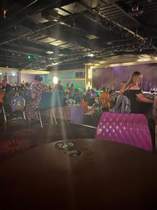 a group of people sitting in a room with purple chairs at Berwick Holiday Park Haven in Berwick-Upon-Tweed