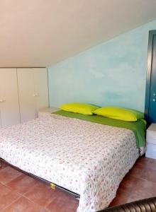 a bedroom with a large bed with yellow pillows at I Gufetti 2 in San Savino