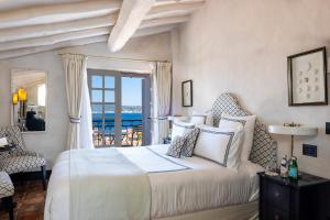 a bedroom with a bed with a view of the ocean at Le Yaca Saint-Tropez in Saint-Tropez