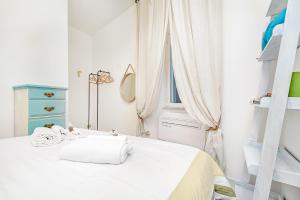 a white bedroom with a bed and a window at La Bella Vita in Vernazza +4 photos