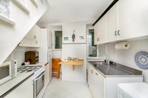 a kitchen with white cabinets and a stove top oven at La Bella Vita in Vernazza