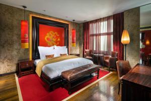a hotel room with a bed and a desk at Buddha-Bar Hotel Prague in Prague