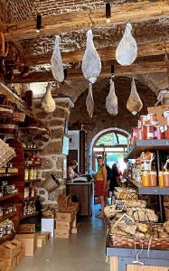 a store with bags hanging from the ceiling in a room at Le Cocon Bord de mer in Belgodère